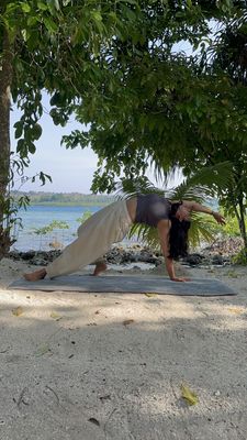 Prajakta Gogate practicing Wild Thing posture (Camatkarasana) on the beach