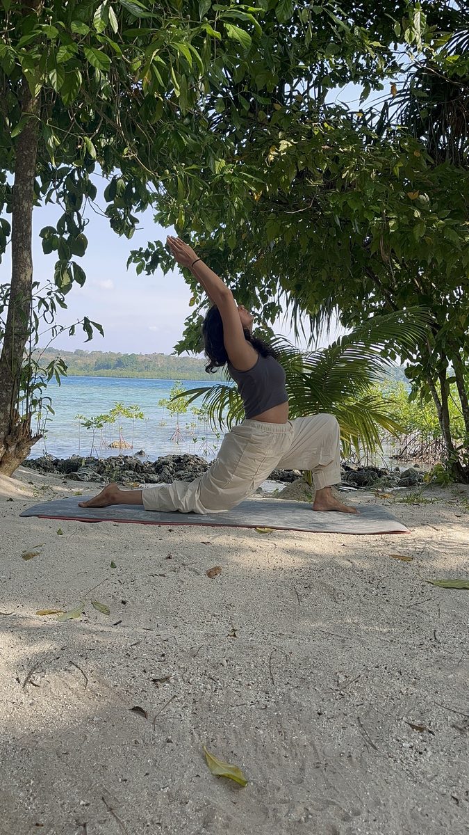 Prajakta Gogate performing Crescent Lunge posture on the beach, Certified Yoga Instructor and Creator of The Journey Called Yoga