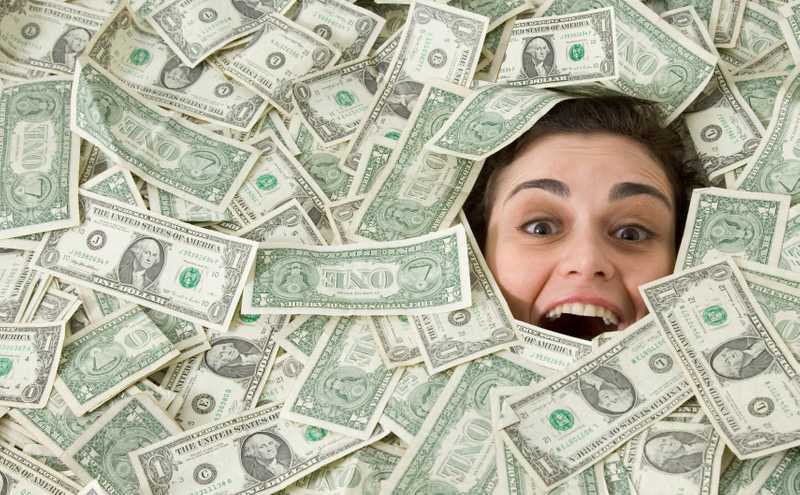 woman s face peeking out of a pile of money 71418271 57d6590e5f9b589b0ad652aa